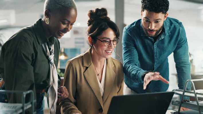 Co-workers having a discussion looking at laptop
