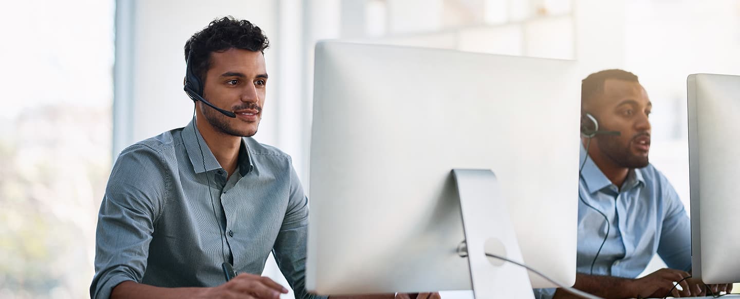 2 tech help men at computers