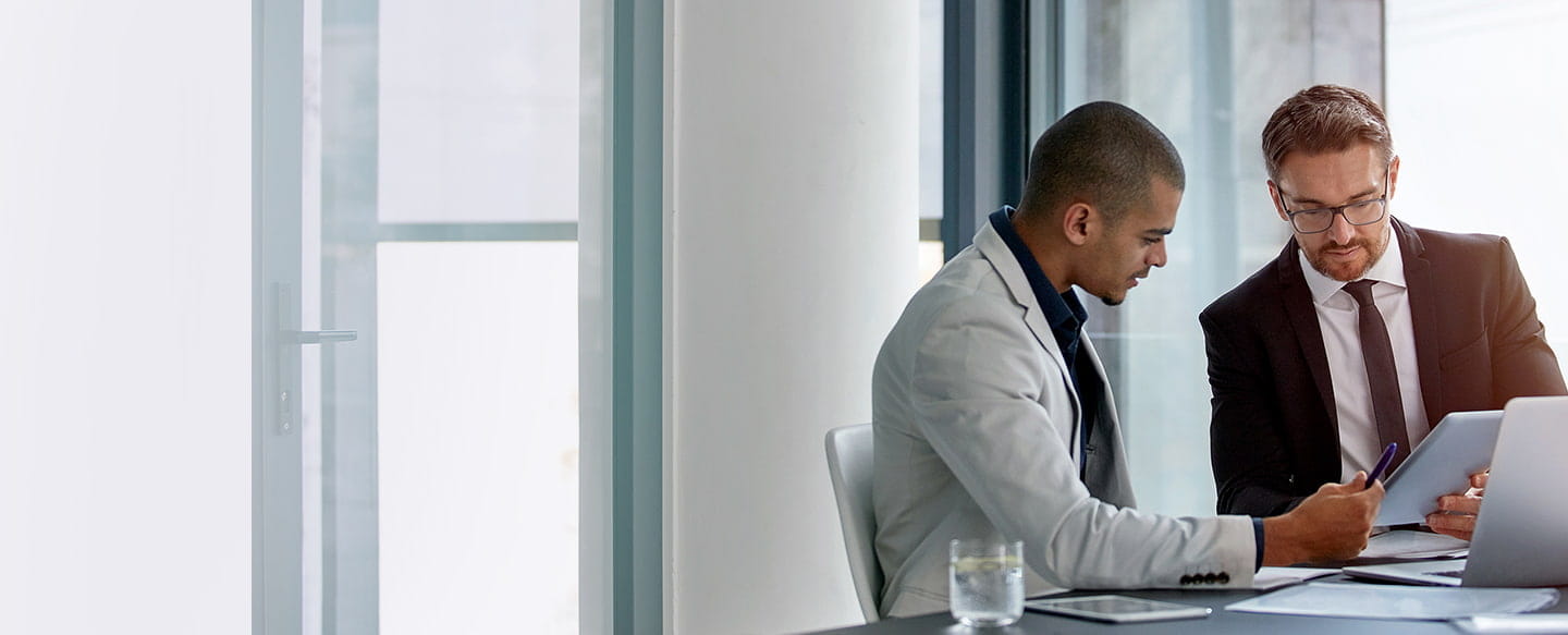 2 men conferring in modern office setting