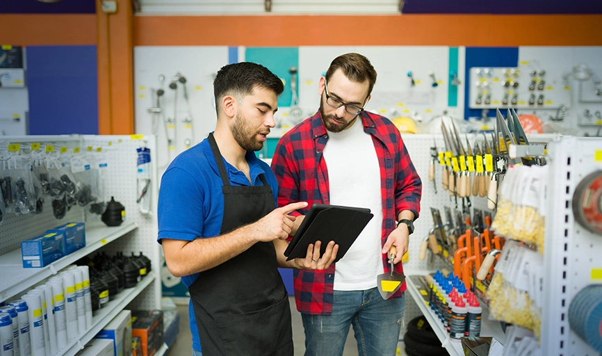 two men in hardware store looking at tablet