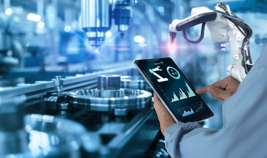 Weblogic migrated to cloud-based app shown on tablet held in unseen worker’s hand in front of an industrial-themed background.