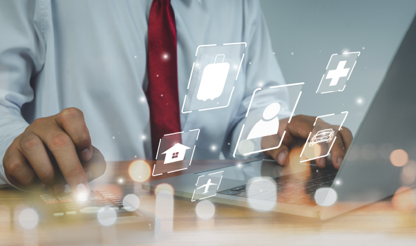 Close-up on businessman using laptop with floating financial icons. UX is enhanced with portfolio management tool