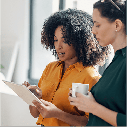 two women coworking at paper