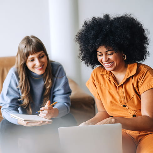 two women and one wearing orange jumpsuit