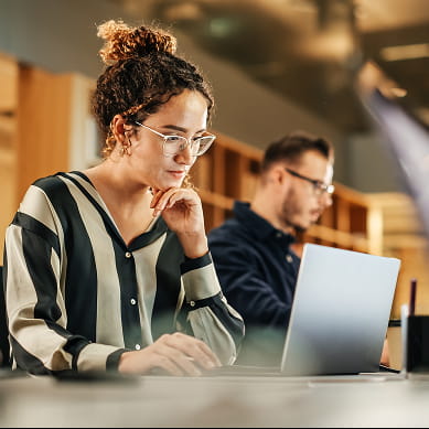 woman in stripped shirt at laptop